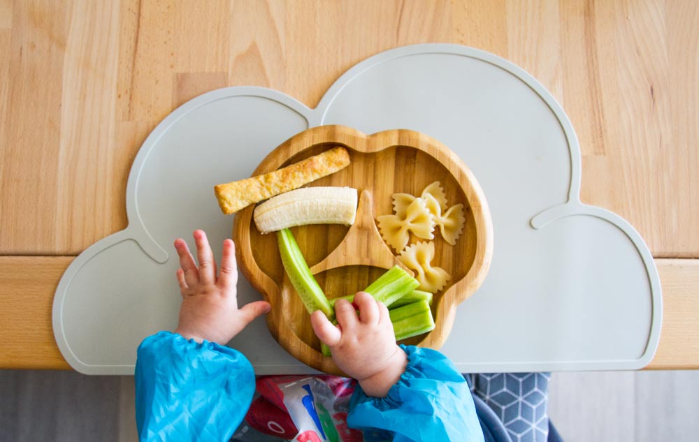 A baby portion of healthy food on a wooden plate