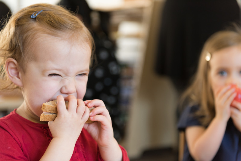 A young child eating a sandwich