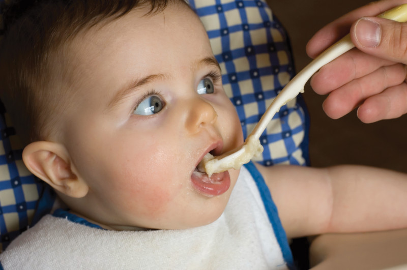 A baby being spoonfed